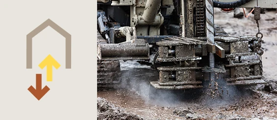 Forage géothermique en cours avec une machine creusant le sol boueux, illustrant le principe de la géothermie fermée utilisant des sondes verticales pour capter la chaleur terrestre.